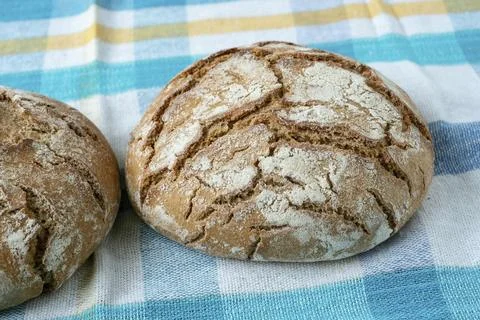 Fresh rustic bread on a checkered towel 스톡 사진