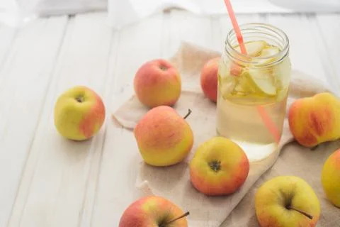 Fresh rustic concept, apples on a white rag on the wooden background Stock Photos