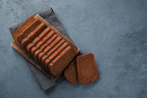 Fresh rye bread cut into slices top view. Stock Photos