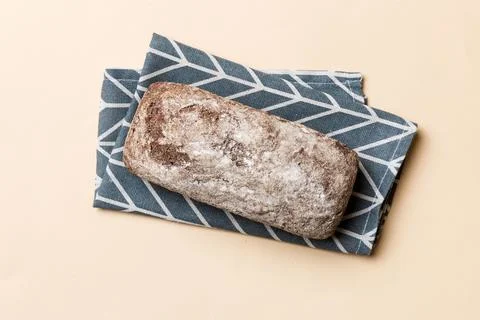 Fresh rye bread on napkin on rustic background, fresh bread top view Stock Photos