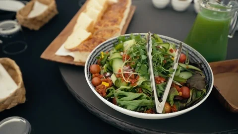 Fresh salad and bread on dining table outdoors Stock Footage 107919757