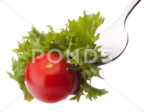 Fresh salad and cherry tomato on fork isolated on white background cutout. Stock Photos