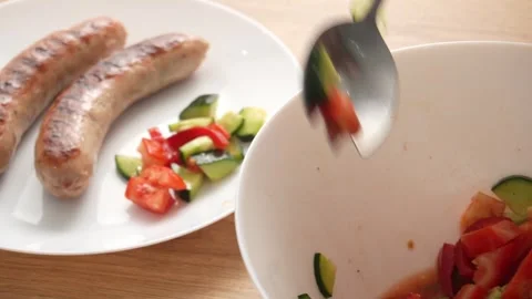 Fresh Salad being transferred from a white bowl to a plate. Stock Footage 253903449