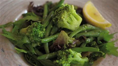 Fresh salad with broccoli, green beans, and mixed greens served in bowl Stock Footage 332630173