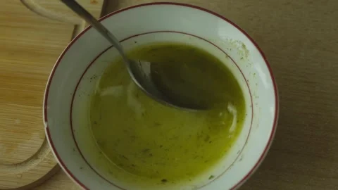 Fresh salad dressing being mixed in the kitchen. Detailed close-up of homemade Stock Footage 340384988