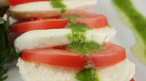 Fresh salad with tomatoes, mozzarella and arugula, closeup (loop) Stock Footage 56846653