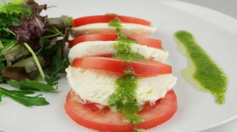 Fresh salad with tomatoes, mozzarella and arugula Stock Footage 56846739