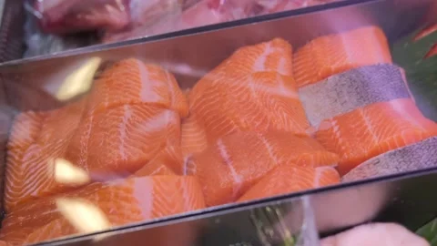 Fresh salmon fillets in a chilled form are displayed on the wind of the store Stock-Footage 201039682