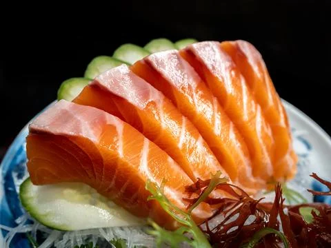 Fresh salmon sashimi, famous japanese food. Five pieces of orange color raw f Stock Photos