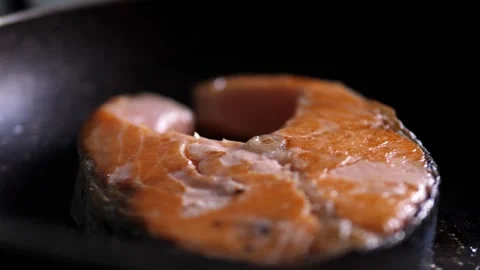 Fresh salmon slice frying with herbs in pan Stock Footage 320257751
