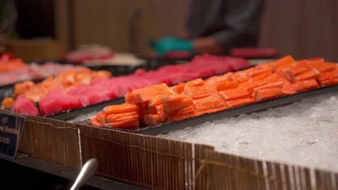 Fresh salmon slice on ice in kitchen bar at the Japanese restaurant Stock Footage 199621352