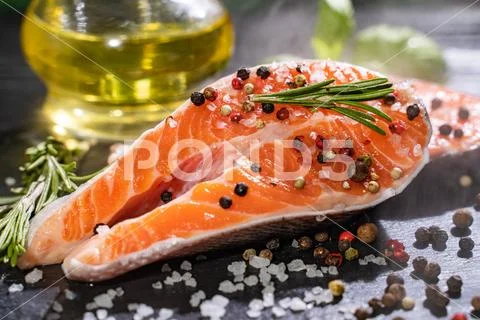 Fresh Salmon With Spices And Lemon On Wooden Table