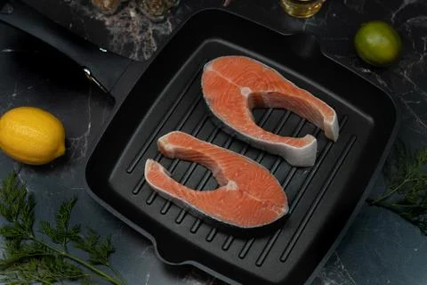Fresh salmon steaks are being prepared for grilling. Stock Photos