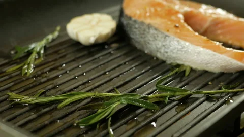 Fresh salmon steaks with grill marks cooking for a healthy meal Stock Footage 97798660