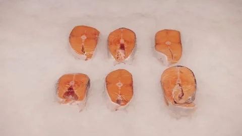 Fresh Salmon Steaks Wrapped In Plastic On Ice Display Stock Footage 327855780