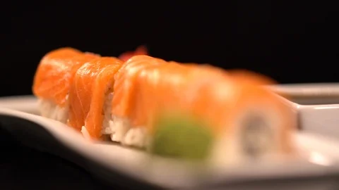 Fresh salmon sushi rolls on a rectangular plate Video stock 96451426