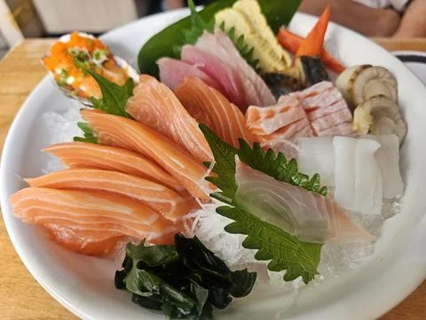 Fresh Sashimi Platter with Assorted Fish and Garnishes on Ice Stock Photos