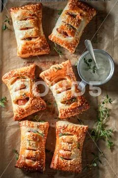 Fresh sausage in puff pastry with tatar sauce and herbs Stock Photos