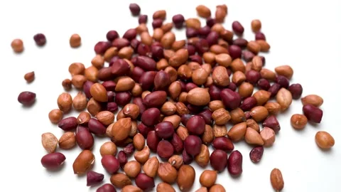 Fresh scattered peanuts view on white table background Stock Footage 282848276