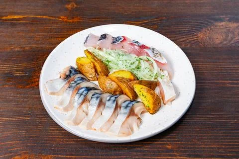 Fresh seafood platter with assorted fish and roasted potatoes Stock Photos