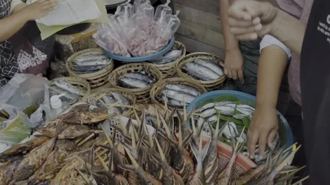 Fresh seafood, various types of fish for sale at a vibrant market stall with ric Stock Footage 325329948