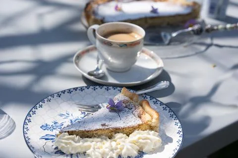Fresh self made easter pie with flower decoration and coffee outdoor. Stock Photos