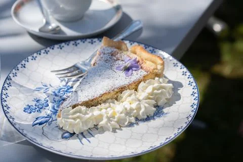 Fresh self made easter pie with flower decoration and coffee outdoor. Stock Photos