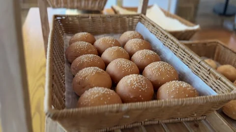 Fresh sesame bread buns in wicker basket Stock Footage 336643800