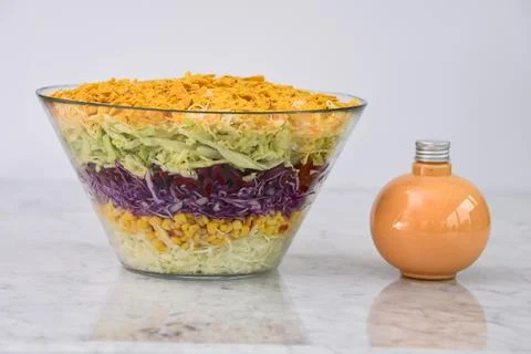 Fresh Seven Layer Salad in a clear glass bowl with layers of shredded lettu.. Stock Photos