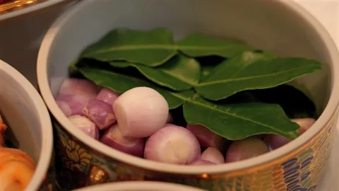 Fresh Shallots and Kaffir Lime Leaves in Benjarong Bowl Stock Footage 336706963
