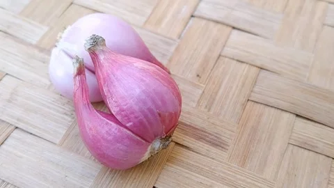 Fresh Shallots Displayed on Bamboo Mat Stock Footage 340618938