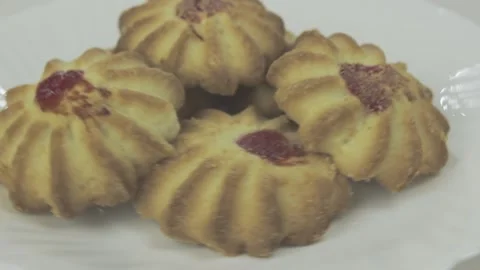 Fresh shortbread cookies with fruit jam rotating on a white plate Stock Footage 131220451