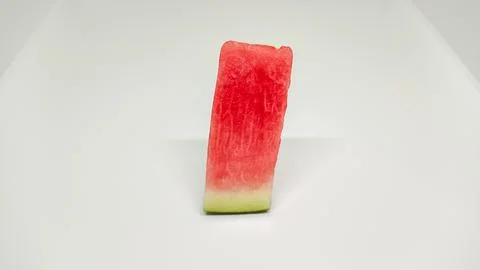 Fresh single slice of watermelon on a plain white background. Stock Photos
