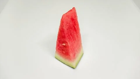 Fresh single slice of watermelon on a plain white background. Stock Photos