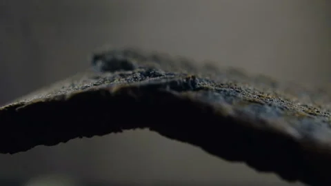 Fresh slice of black bread is broken open in slow motion at 120 fps Stock Footage 101729084