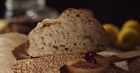 Fresh slice of buckwheat bread with flax seeds on the table Stock Footage 170539670