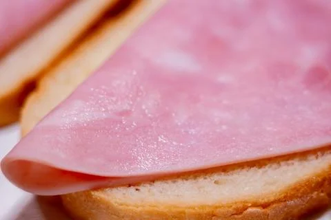 Fresh slice of cooked ham on toasted white bread for breakfast or snack Stock Photos