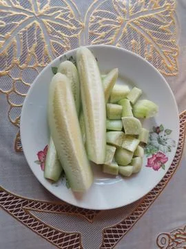 Fresh Slice cucumber in a plate at Table Stock Photos