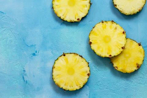 Fresh slice pineapple on stone background or slate with copy space. Stock Photos
