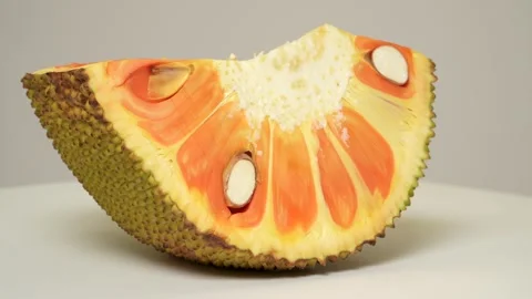 A fresh slice of red-flesh jackfruit spinning on a white background. Stock Footage 316536366