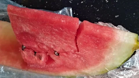 Fresh slice of red watermelon moving in this bright video footage Stock Footage 339248158