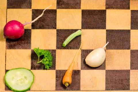 Fresh slice vegetables on the cutting chess board. Stock Photos