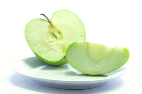 Fresh sliced apple two size on white plate Stock Photos
