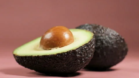 Fresh sliced avocado on pink background close-up. Stock Footage 262748923