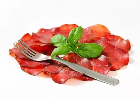 Fresh sliced beef carpaccio with basil leaf Stock Photos