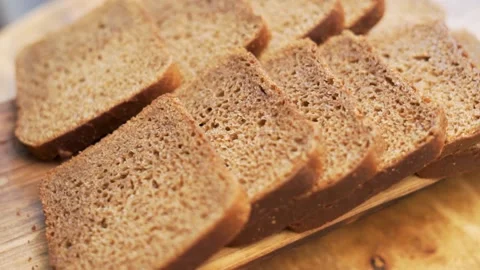 Fresh Sliced Black Rye Bread on A Tray, Close-up. Slices of Healthy Black Bread  Stock Footage 154243277