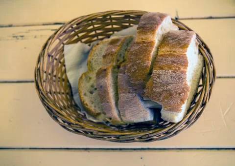 Fresh sliced bread on the kitchen table in a basket. Stock Photos