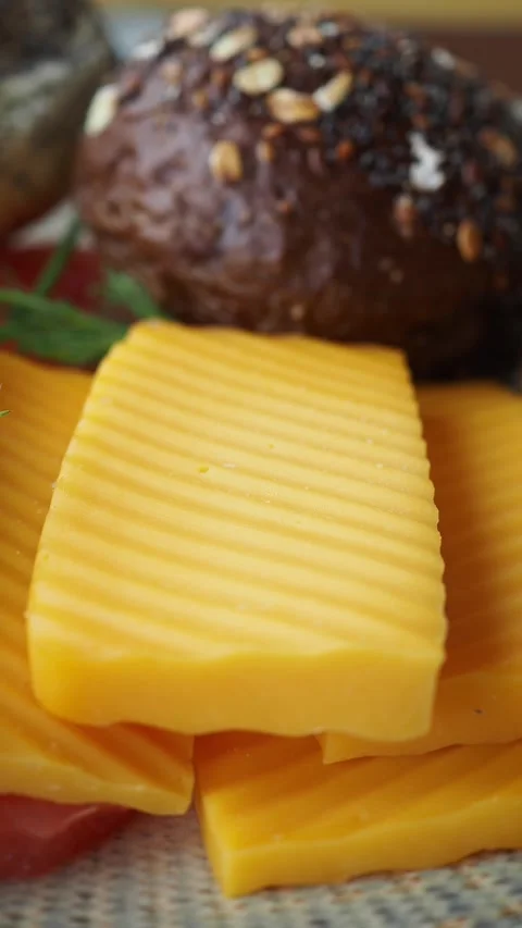 Fresh Sliced Cheese and Bread Rolls with Herbs Stock Footage 336294904