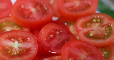 Fresh sliced cherry tomatoes spinning Stock Footage 129826844