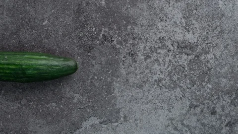 Fresh, sliced cucumber on the black background Video stock 101322436